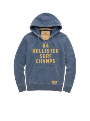 Blå hoodie Hollister Surf Champs - Blå hoodie från Hollister med gul text '64 Hollister Surf Champs' på bröstet. Klassisk känguruficka framtill och huva med dragsko. Hoodien har en tvättad vintage-look och detaljer i form av små vita färgstänk. Perfekt för en avslappnad streetwear-stil. Den ska vara lite sliten” de ska vara så på själva tröjan