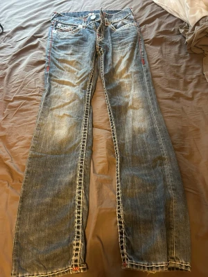 Blå bootcut true religon jeans - Säljer ett par blå bootcut jeans från True Religion i storlek 29. Jag är 166 och dem sitter bra på mig