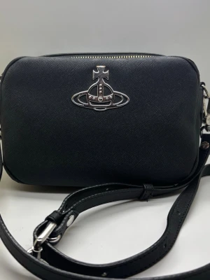 Vivienne Westwood Anna Camera Bag Unisex  - ✨ Vivienne Westwood Anna Camera Bag Unisex 🖤  ✨ Good Condition! Some light surface wear at the top of the bag, not noticeable when wearing. (shown in the last photo)  ✅ Authentic  💌 Feel free to message me if you have any questions!