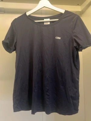 Mörkblå t-shirt från ICANIWILL - Snygg mörkblå t-shirt från ICANIWILL med diskret logga på bröstet. Klassisk rund halsringning och korta ärmar. Perfekt för dig som gillar enkel och stilren design. Tillverkad i mjukt material som känns skönt mot huden.