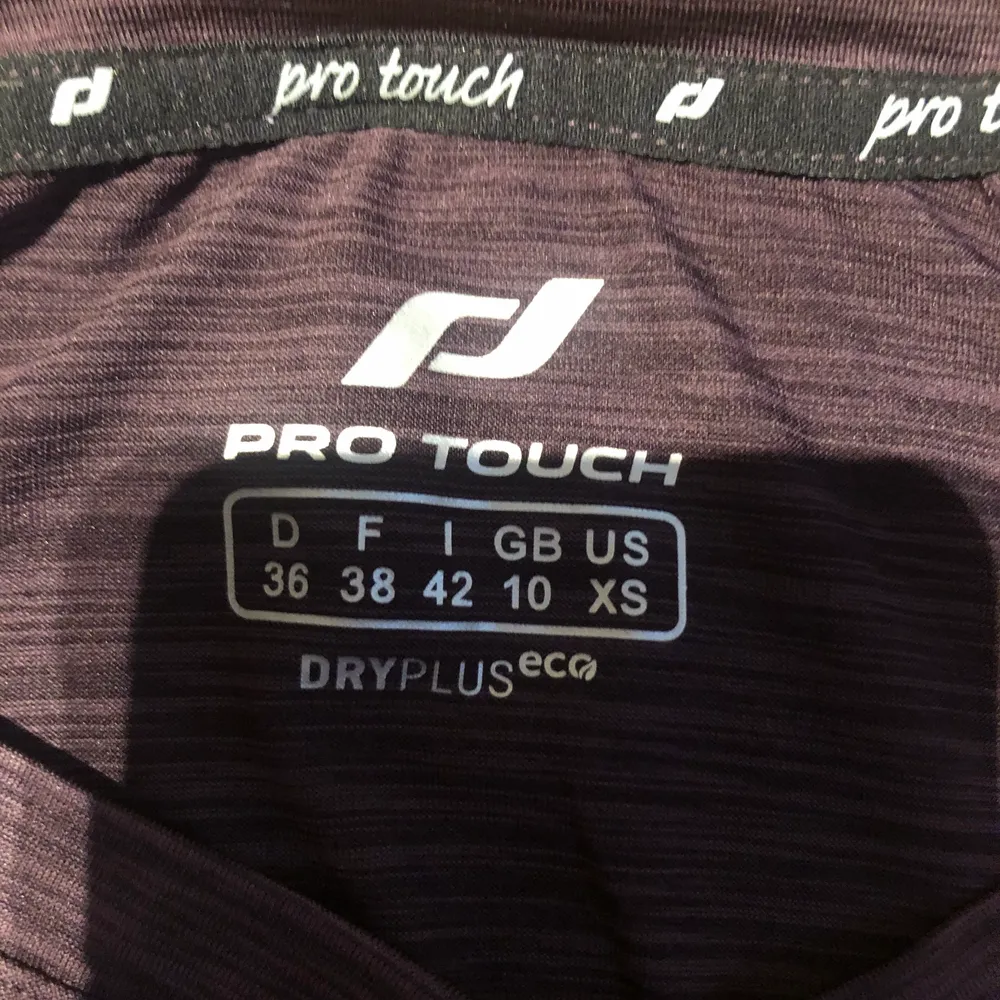 En mörk lila långärmad träningströja från pro touch men köpt på Intersport. Köptes för ett år sen. Är i storlek 36. Aldrig använd.. Toppar.