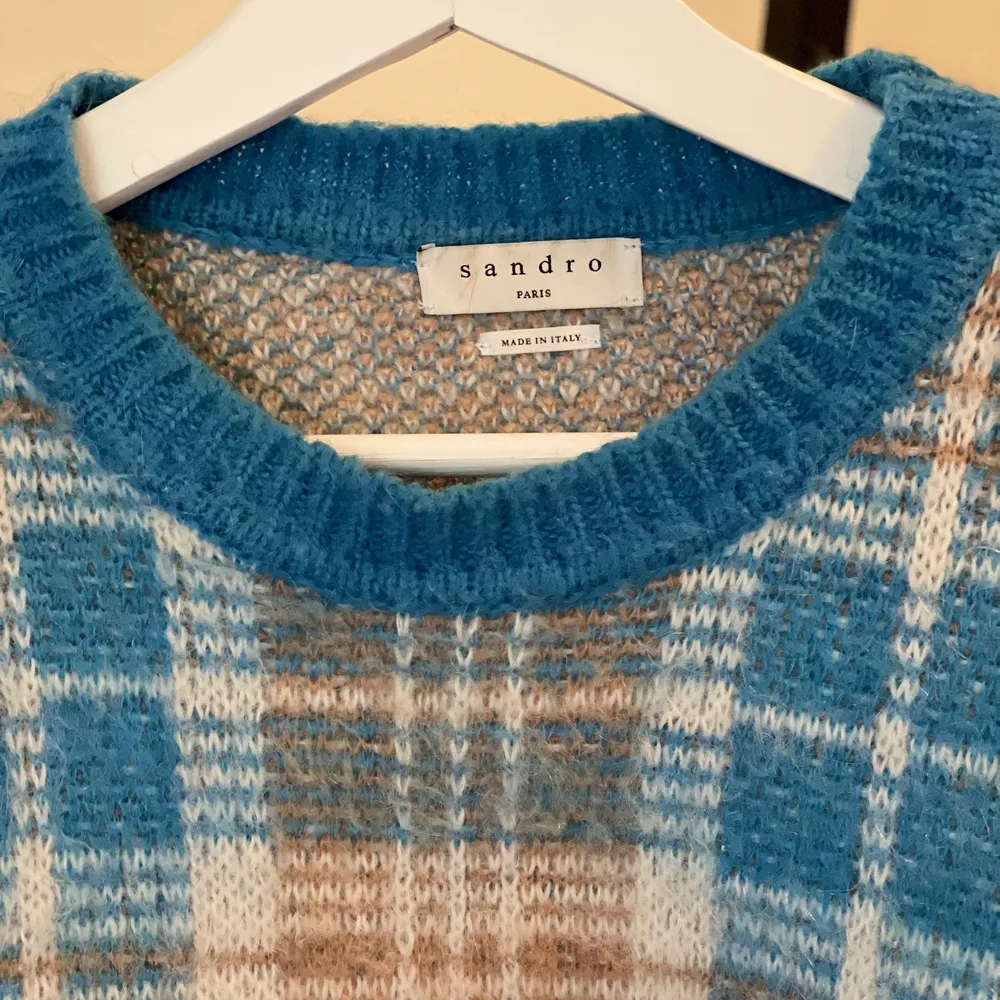 En supermysig stickad tröja från sandro i rutigt mönster av blått, beige och vitt. Originalpris: 2500kr. Stickat.