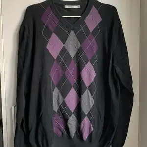 Snygg svart tröja med lila rutor! 2XL men passar mindre storlekar också. Lägg ett bud eller köp direkt för 120!