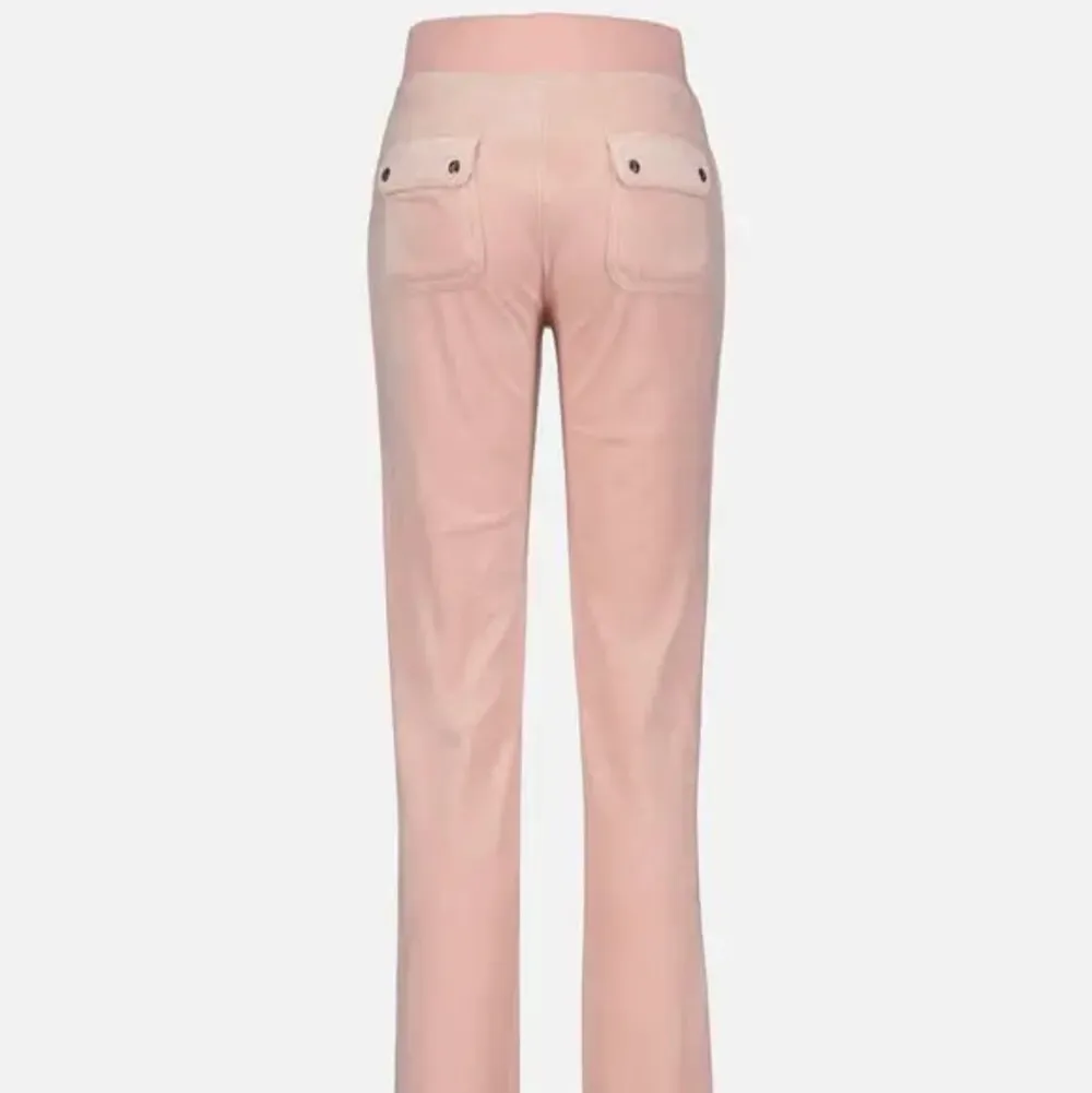 Säljer mina ljus rosa/beiga juicy couture del ray classic velour byxor i storlek L. De är helt oanvända endast provade. . Jeans & Byxor.
