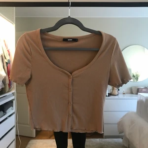 Brun topp - Fin brun t-shirt med knappar i storlek S från bikbok, knappt använd
