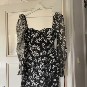 Blommig klänning strl 36  - Helt oanvänd! Populär svartvit blommig klänning med puffärm och dragkedja i ryggen. 🌸 Matcha med en skinnjacka och ett par boots!   Strl 36