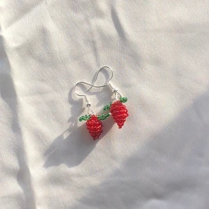 Jordgubs örhängen  - Söta små handgjorda jordgubbs örhängen! 🍓 De är gjorda utav små seed beads. Vet tyvärr inte ifall krokarna är nickelfria. Vid fler frågor kontakta mig. Frakt tillkommer på 13kr ❤️