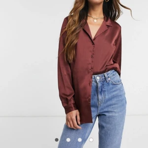 ASOS DESIGN relaxed satin long sleeve shirt in berry - Nyskick då den fortfarande är kvar i paketet ajg fuck den i.  Aldrug anvönd. Säljer då den inte passar. Storlek UK 10.