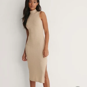 Ribbad  klänning  - En ribbad klänning med ett slit från NA-KD i storlek 36. Har använt den en gång så den är i bra skick 