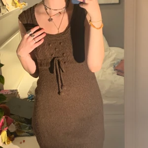 Klänning - Brun stickad klänning med snöre så man kan spänna in den! Supersöt och nästan aldrig använd.