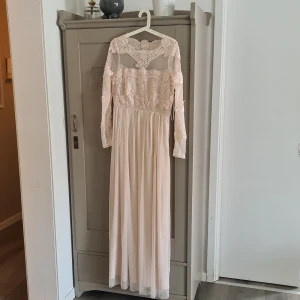 Vila klänning. - Långklänning med spets i storlek 42 som aldrig har blivit använd.