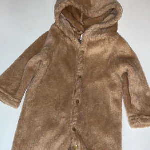 Teddyoverall baby.  - Säljer nu denna fina baby overall i strl 56. Den har öron, svans och fötter så helt perfekt för att hålla bebisen varm.   Kan skickas men då står köparen för frakten. Skickas endast spårbart för köparens och min säkerhet. 