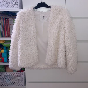 Vit ull koft/jacka H&M - Vitt fejk ull tjockare kofta. Man kan tillexempel ha ovanpå en klänning om man ska kalas/bröllop, fest! Använd några få gånger inga anmärkningar. Passar till barn i ålder 10-15 enligt min åsikt❤️