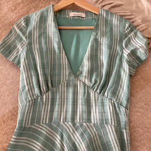 Miniklänning  - En miniklänning, har ett märke på ryggen (syns knappt) använd ett antal gånger.