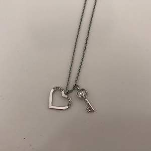 Swarovski necklace with heart and key pendant. Almost never worn but some stones are missing in the heart (as pictured) although it is not too visible