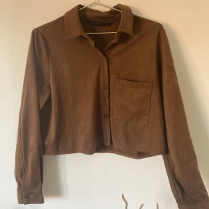 Mockafärgad Skjorta - Från Zara, orginalpris 400 kr. Kort i modell, skön, luftig, passar till höga byxor exempelvis. M i storlek men passar främst en i S.  Fraktar eller möts!  