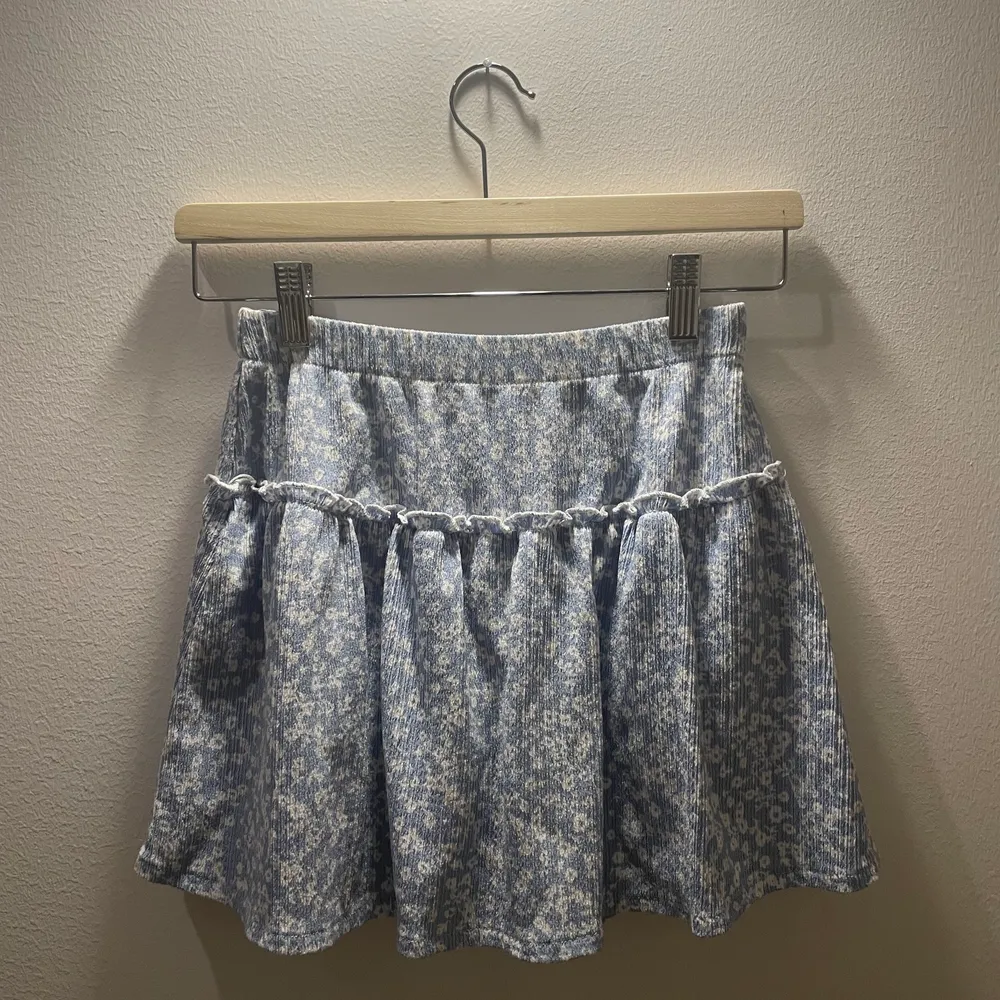 En jättefin ljus blå volang kjol från zara. Den har ett jättefint blommigt mönster. Kjolen har också inbyggda shorts :). Hameet.