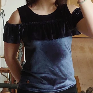 Topp med volang - Mörkblå topp med off shoulder och volang från Ü. Är i bra skick. 