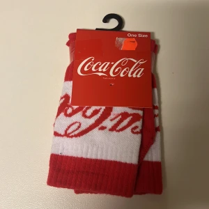 Coca cola strumpor  - Ett par strumpor från bik bok. Står Coca cola på. Lite högre modell. Storlek one size.