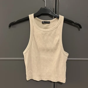 Trendig topp från ZARA - Superfin liten topp i en slags biege nyans, använd några få tal gånger, köpt förr förra sommaren! Har inga märken hål osv. Lappen sitter kvar. Den har storlek m men skulle nog säga att den passar bättre på en S