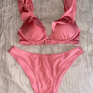 Helt ny bikini  - Jätte söt rosa bikini med volanger upptill, har aldrig använt den men klippt bort lappar. Strl M i underdelen och 70B i överdelen. 