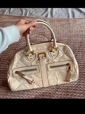 Vintage Y2K Handbag From Marc Jacobs - Bought in Italy in the late 00s. Don’t have the original receipt or chain that goes with it. The flaws are few and pictured in the photos. The overall state of the bag is good.