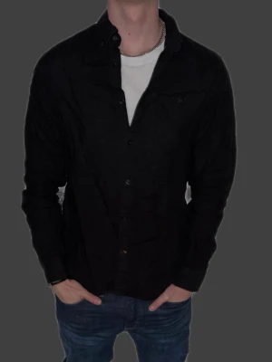 Svart linneskjorta från Morris - Svart linneskjorta från Morris i storlek M. Fint skick till ett bra pris. Nypris: 1995kr. Mitt pris: 349kr. Vid frågor eller funderingar, tveka inte att höra av dig.