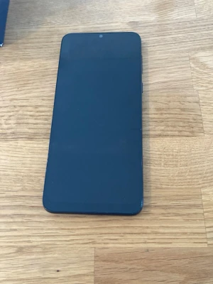 Motorola Moto E13 64GB Olåst Nyskick! - Säljer en Motorola Moto E13 64GB Cosmic Black med grym batteritid tack vare sitt stora 5000 mAh-batteri. Telefonen är i nyskick enligt bilder utan skador eller repor. Telefonen är lätt och bekväm trots stor 6,5-tums skärm. Har ren och modern Android 13 som känns snabb och lätt. AI-kamera, 90hz, Dolby Atmos, Dual SIM, USB-C, AUX, Micro-SD, IP52-skydd etc. Fås i originalförpackning med laddare och manual.  Begagnat pris: 1400 SEK Mitt pris: 689 SEK  Skickas alltid snabbt och spårbart. Skriv vid fr