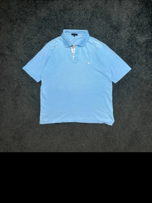 Authentic Burberry Polo Shirt - Light Blue - Size S - Selling a classic and authentic Burberry London short-sleeve polo shirt. A perfect staple piece for a smart-casual look! Key Details:  Brand: Burberry London (Made in England)  Size: S (Small)  Color: Light Blue  Material: 100% Cotton Features:  Signature Burberry Nova Check pattern on the inner button placket.  Iconic embroidered Burberry equestrian knight logo on the left chest.  High-quality, breathable cotton fabric.  Feel free to message me if you have any questions or need specific measure
