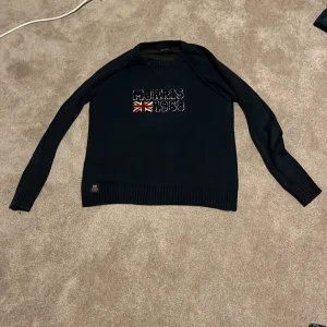 Mörkblå stickad tröja Morris - Snygg mörkblå stickad tröja från Morris med tryck på framsidan, storlek M