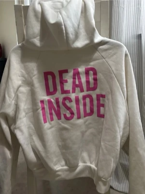 Vit hoddie med tryck - En vit hoddie med tryck. Finns en liten fläck på ärmen (syns på bild 2) annnars fin