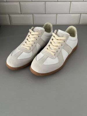 Vita Maison Margiela Gats - Säljer nu dessa vita Maison Margiela gats för 1299kr! Skriv om du har någon fundering om skorna.