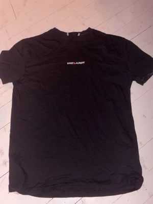 Saint Laurent t-shirt - Säljer denna snygga tröja pga att den är för liten för mig nu! Den är inte fejk men lite äldre modell. Knappast använd och priset går såklart att diskutera. Står L i storlek men passar mer S!