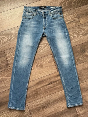  Replay Grover  - Snygga ljusblå Replay Grover med klassisk femficksdesign och slitna detaljer framtill och baktill. Jeansen har en något tvättad look och är tillverkade i stretchigt denim för extra komfort. Perfekta för en avslappnad och trendig stil.