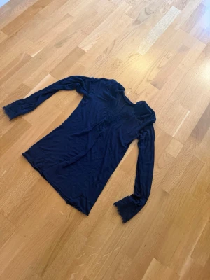 Intimissimi cashmere tröja - Snygg mörkblå långärmad topp med spetsdetaljer vid halsringningen och ärmsluten. Tunn och stretchig i materialet, perfekt för lager på lager. Figurnära passform och feminina detaljer gör den enkel att styla till olika looks.