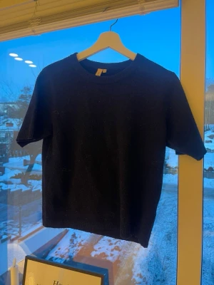 Mörkblå stickad t-shirt - En stilren mörkblå stickad t-shirt med kort ärm och rund halsringning. Tröjan har ribbstickade detaljer vid hals och nederkant, vilket ger en snygg och enkel look. Storlek xs från Nelly🤍🤍🤍🤍💗💞💞