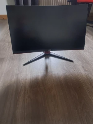 AOC gaming 185hrz skärm svart/röd - Säljer en snygg och stilren datorskärm från AOC med svart och röd design. Skärmen har en böjd form och står på ett robust stativ med tre ben. Perfekt för gaming eller arbete vid datorn.