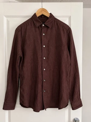 Massimo Dutti skjorta Brun/Vinröd – Strl M - Säljer en väldigt fin linneskjorta från Massimo Dutti i mörk brun/vinröd ton.  100% linne med riktigt skön och luftig passform. Perfekt till vår/sommar, mycket bra skick o begränsat använd.                                                          Storlek: M                                                                         Kan skickas eller mötas upp