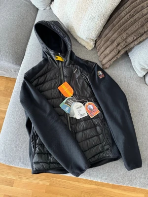 Parajumpers - Tja, säljer min Parajumper cardigan i ett mycket gott skick. Jackan har använts en vårtermin och har knappt några tecken på användning. Jackan är varm och skön och kan användas i alla arstider. Säljer jackan pga att jag köpt en annan jacka da denna bara ligger hemma just nu. Kvitto och tags finns och medföljs vid köp. Jackan är i storlek XL men passar även L. Vid mer frågor är det bara att höra av sig!
