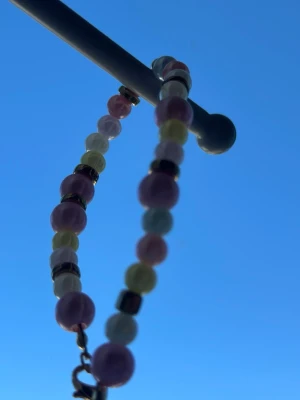 Homemade bracelet  - This is a handmade bracelet by myself, with yellow, white, purple and pink pearls. It has gold beads between some. Beautiful bracelet to wear whenever, with an adjustable part so you can make it bigger or smaller. Check out my profile for more handmade pieces 🌸