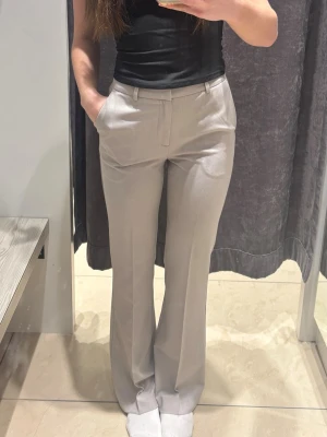 Grå/beige kostymbyxa - Flared högmidjade kostymbyxor från Cubus. I storlek 34/Regular och endast använda en gång så i super bra skick🥰Nypriss 499kr