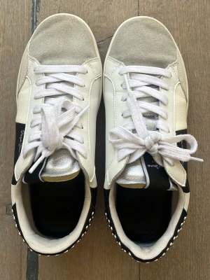 Vita och svarta sneakers Pepe Jeans - Säljer Pepe Jeans skor. Väldigt fint skick, förutom att det saknas en rund silverplopp på baksidan av skon. Vissa av plopparna är lite utbuktade, men annars fina! Storlek 38!☺️💗🌸Köpta för 1000 och säljer dem för 650!