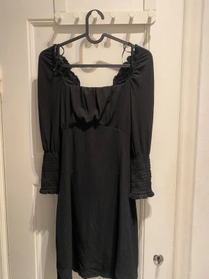 Svart kort klänning med knytning i ryggen - Säljer denna då den tyvärr inte kommer till användning 