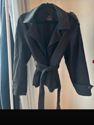 Kort trenchcoat - Endast använd en gång så i nyskick! Jättefin och populär modell 