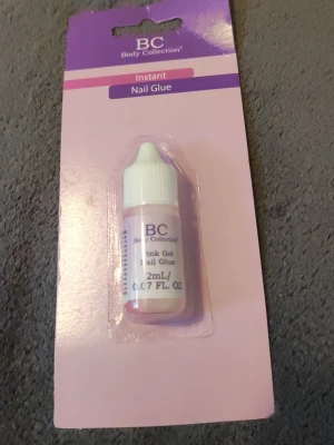 BC Body Collection nagellim 2ml - Nagellim från BC Body Collection, Instant Nail Glue i en liten flaska på 2 ml. Perfekt för att fästa lösnaglar eller nageldekorationer. Kommer i en rosa och vit förpackning med praktisk droppflaska för enkel applicering.