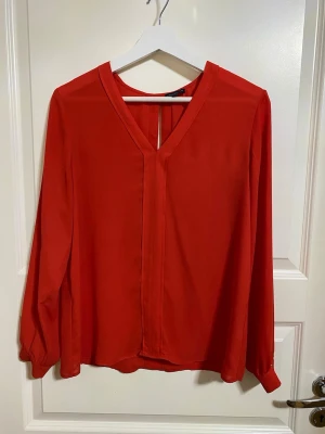 Röd v-ringad blus - Snygg röd blus från STOCKH LM med v-ringning och långa ärmar. 