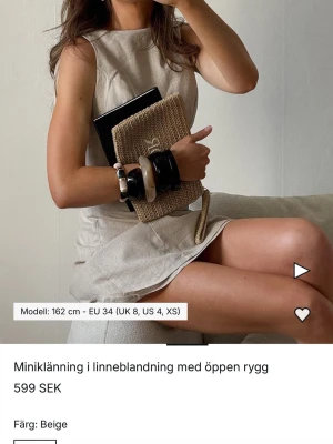 Beige miniklänning i linneblandning - Stilren beige miniklänning i linneblandning med ärmlös design och öppen rygg. Klänningen har en enkel, rak passform och rund halsringning. Helt ny med prislapp kvar. 