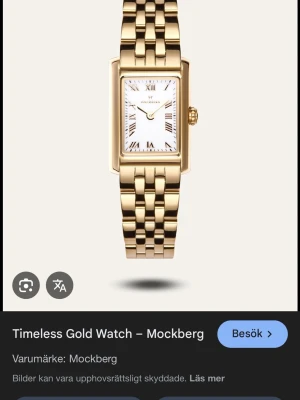 Mockberg guldfärgad klocka rektangulär - Stilren klocka från Mockberg i guldfärgat metallarmband och rektangulärt ur med vit urtavla och romerska siffror. Klassisk design som ger en lyxig känsla och passar perfekt till alla outfits.