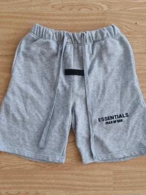 Grå Essentials Fear of God shorts - Säljer ett par grå mjukisshorts från Essentials Fear of God. Storlek S 160-170 cm