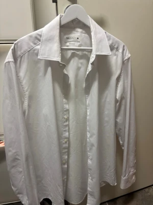 Kostymset från Zara Man svart & vit - Säljer ett klassiskt kostymset från Zara Man med svart kavaj och matchande svart slips samt en vit skjorta. Köptes april 2025. Används en gång. Helt nytt!